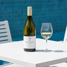 Load image into Gallery viewer, Dog Point Sauvignon Blanc wine bottle and glass on a table with a pool in the background