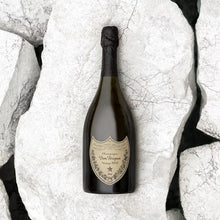 Load image into Gallery viewer, Bottle of Dom Perignon champagne on a textured white surface