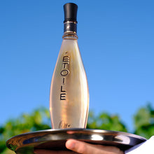 Load image into Gallery viewer, Bottle of Etoile champagne on a silver tray against a blue sky