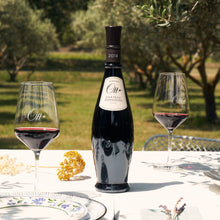 Load image into Gallery viewer, Domaines Ott Chateau Romassan Bandol Rouge red wine bottle and glasses on a table with an olive grove in the background
