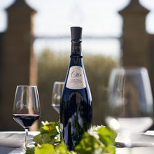 Load image into Gallery viewer, Bottle of Domaines Ott Chateau Romassan Bandol Rouge red wine with a glass on a table outdoors