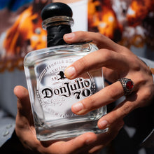 Load image into Gallery viewer, Man holding a bottle of Don Julio 70 agave spirit with a blurred background