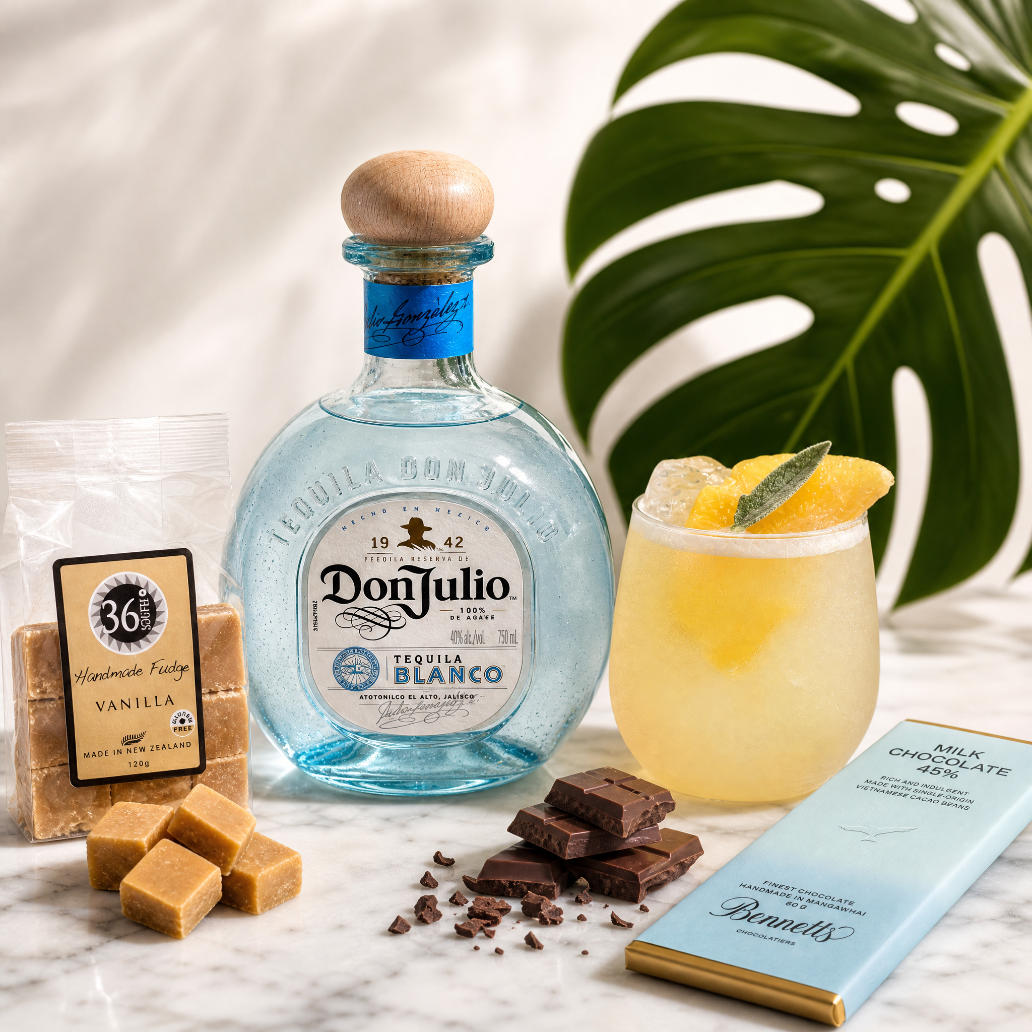 Load image into Gallery viewer, Don Julio blanco tequila bottle with a cocktail, fudge, and chocolate on a marble surface.