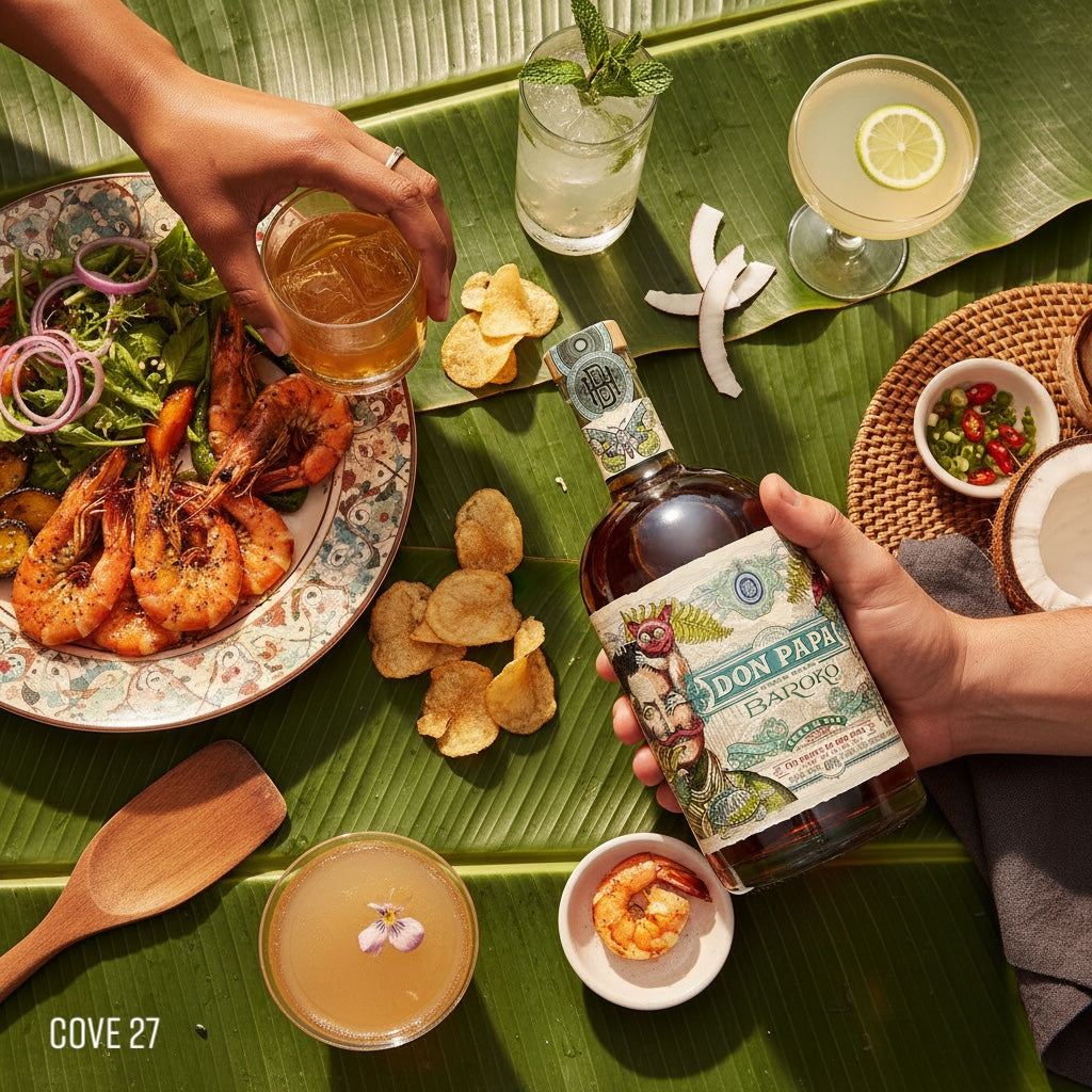 Load image into Gallery viewer, Person holding a bottle of Don Papa Baroko Rum with a tropical setting featuring food and drinks.o
