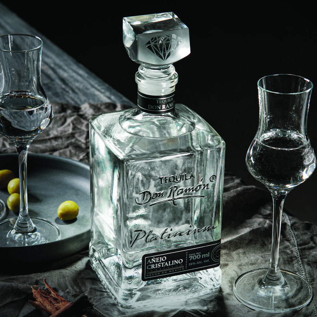 Load image into Gallery viewer, Don Ramon Platinium tequila bottle with two glasses on a dark surface