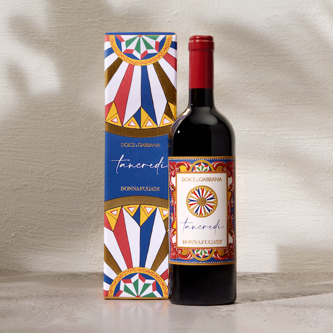 Load image into Gallery viewer, Bottle of Donnafugata Tancredi Dolce Gabbana red wine with decorative gift box on a textured surface