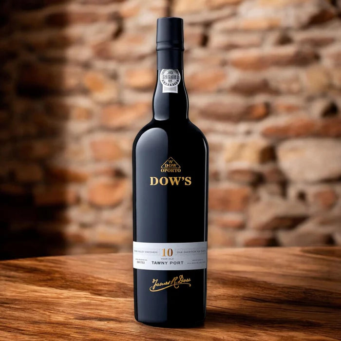 Load image into Gallery viewer, A bottle of Dow's Port wine on a wooden table with a brick wall in the background