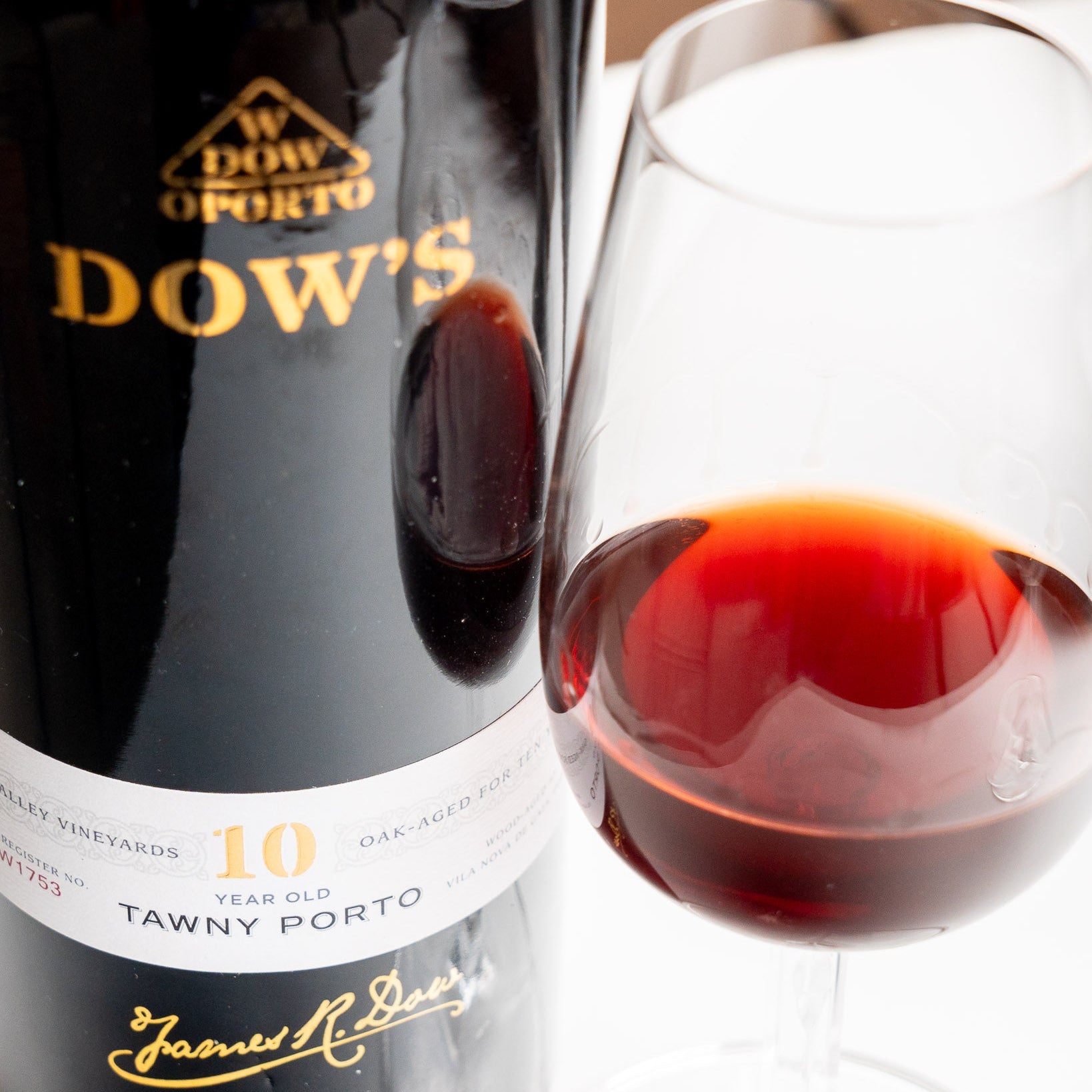 Load image into Gallery viewer, Dow's Tawny Porto bottle with a glass of red wine.