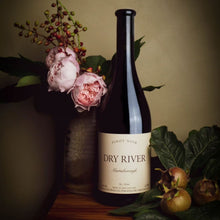 Load image into Gallery viewer, Dry-River-Pinot-Noir wine bottle labeled &#39;Dry River&#39; with flowers and fruits on a wooden surface