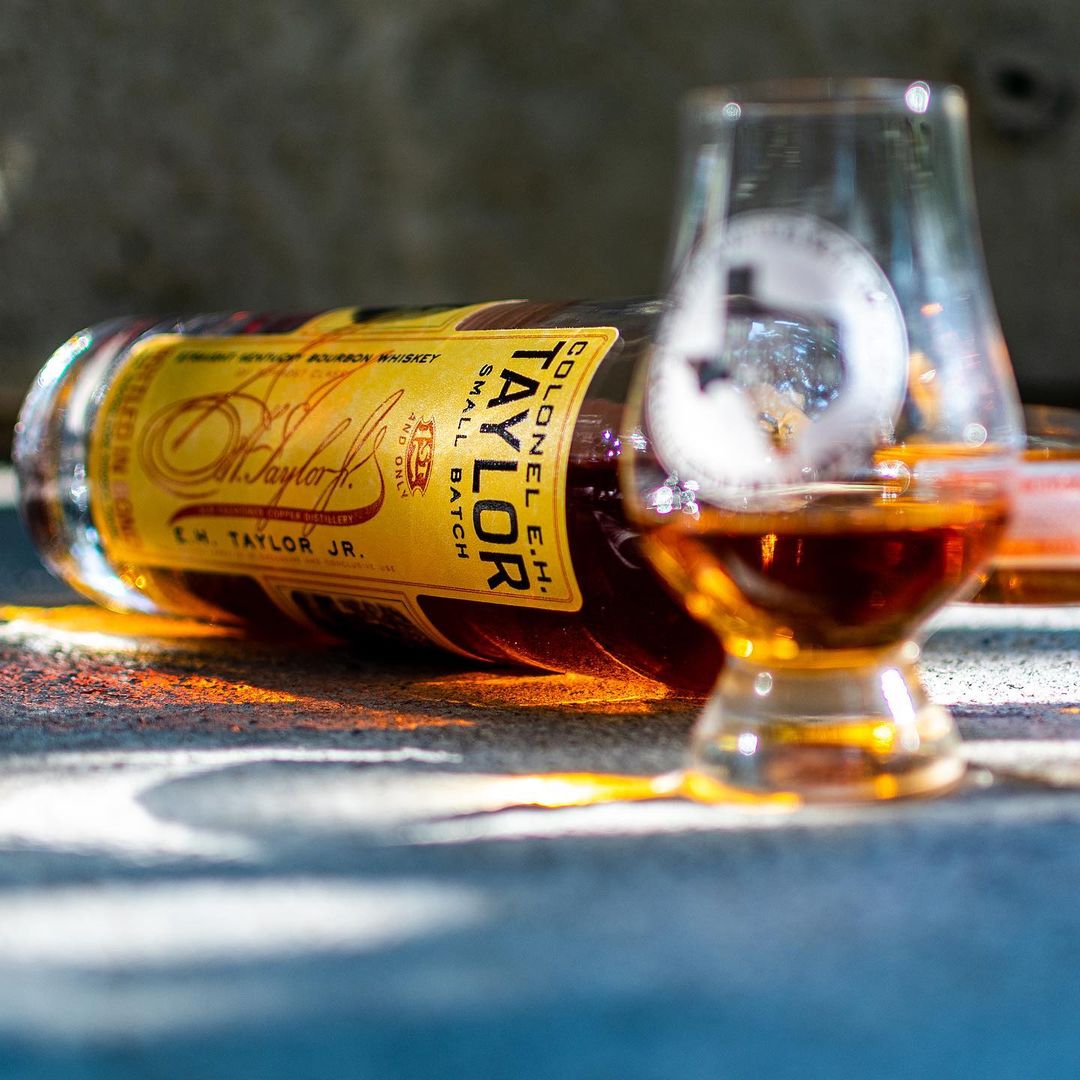 Load image into Gallery viewer, Bottle and glass of whiskey on a textured surface