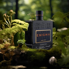 Load image into Gallery viewer, Enigma 1870 gin bottle in a natural setting with greenery