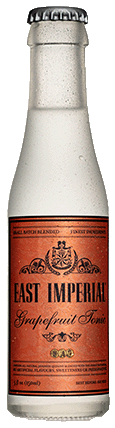 A bottle of East Imperial Grapefruit Tonic with a white label and brown text, indicating the product name and volume.