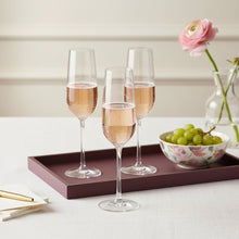 Load image into Gallery viewer, Four Eisch Vinezza champagne flutes with pink champagne on a tray with a bowl of grapes and a vase of flowers.