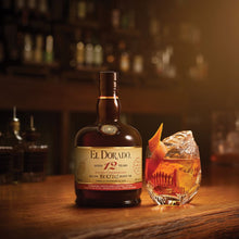 Load image into Gallery viewer, El Dorado 12-year-old rum bottle with a cocktail on a bar
