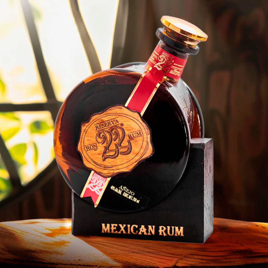 Load image into Gallery viewer, Bottle of El Ron Prohibido Reserva 22 Mexican Rum on a wooden surface with blurred background