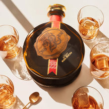 Load image into Gallery viewer, Alcohol bottle with glasses on a white surface, featuring text in Spanish.