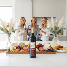 Load image into Gallery viewer, Three women enjoying wine in a kitchen with a charcuterie board and a bottle of Elderton-Command-Shiraz wine in the foreground.
