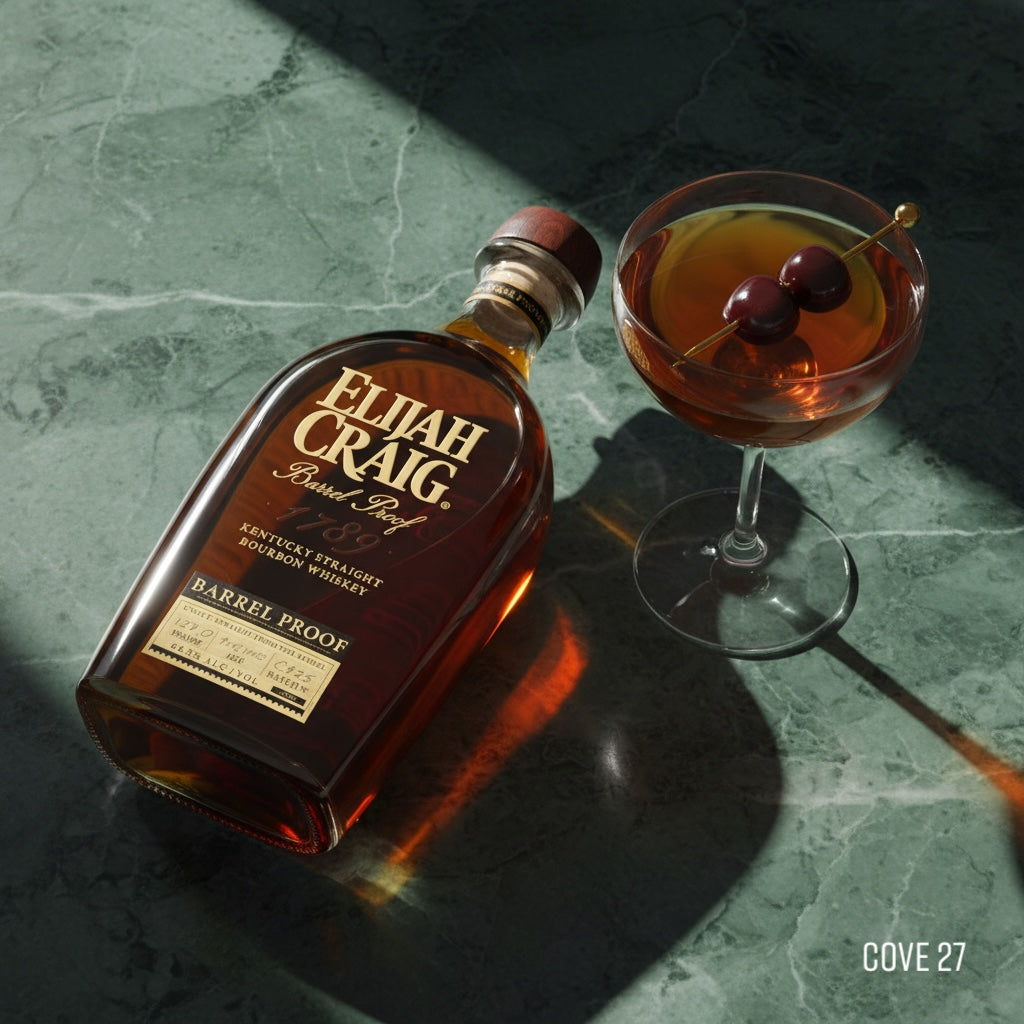 Load image into Gallery viewer, Bottle of Elijah Craig BARREL PROOF bourbon and a cocktail with a cherry on a marble surface.