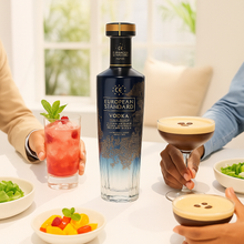 Load image into Gallery viewer, Bottle of European Standard Vodka with cocktails and snacks on a table