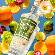 Load image into Gallery viewer, Bottle of Farmers Botanical Gin surrounded by fruits and flowers on a blue background
