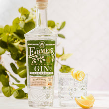 Load image into Gallery viewer, Bottle of Farmers Botanical Gin with a glass of gin and tonic on a white background