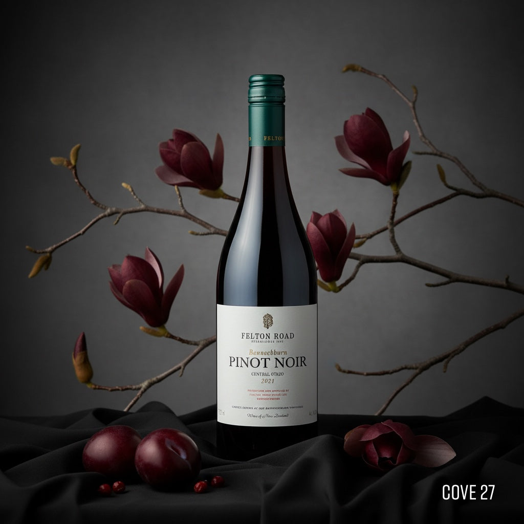 Load image into Gallery viewer, Bottle of Felton Road Pinot Noir with plum and magnolia branches on a dark background