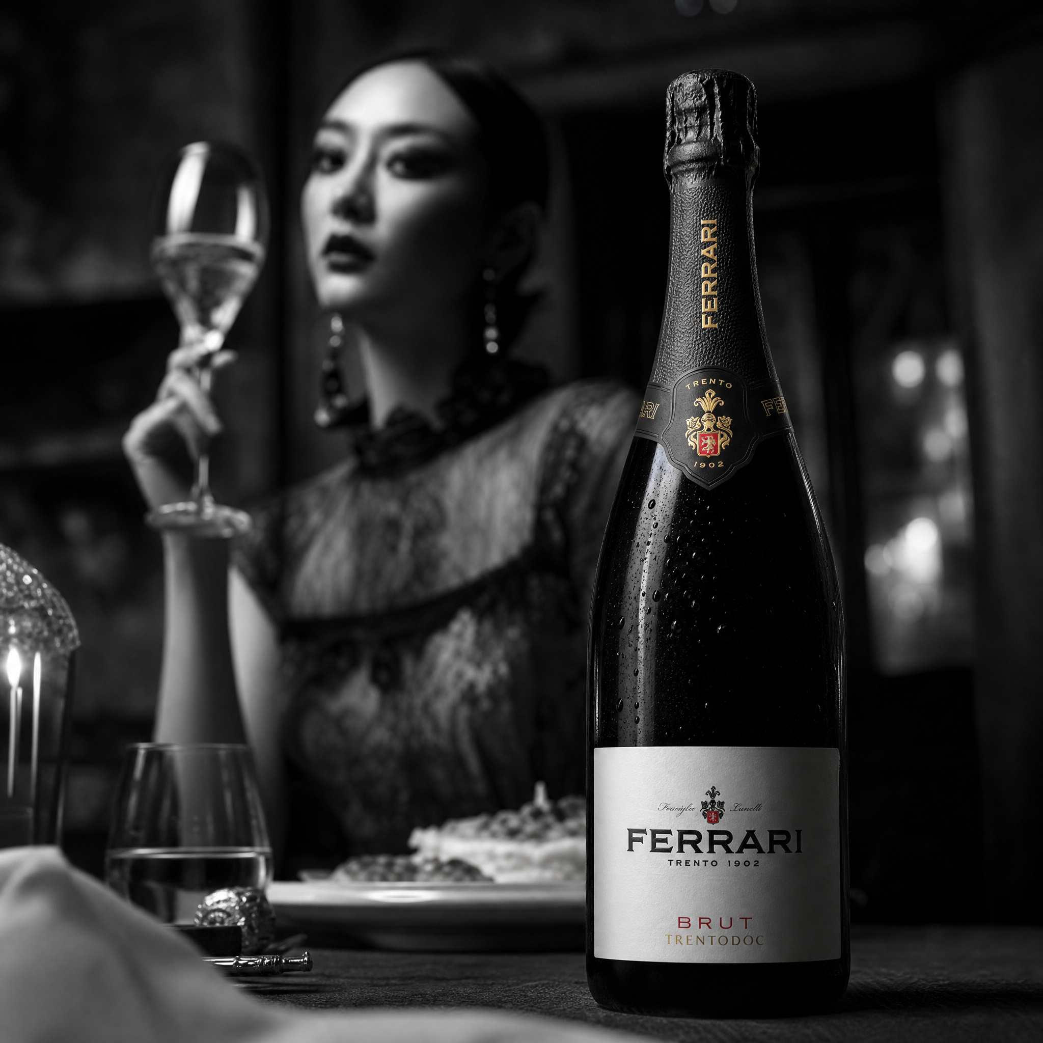 Load image into Gallery viewer, A bottle of Ferrari Brut sparkling wine in the foreground, with a blurred woman holding a wine glass in the background in a dimly lit setting.