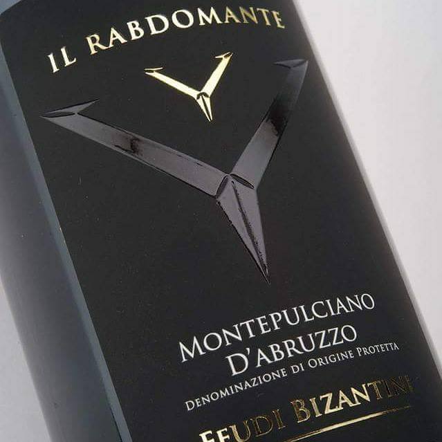 Load image into Gallery viewer, A close up image of the label of a bottle of Feudi Bizantini Il Rabdomante Montepulciano
