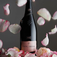 Load image into Gallery viewer, A bottle of champagne on a bed of pink roses