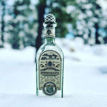 Load image into Gallery viewer, Fortaleza Blanco Tequila bottle with snow on a blurred snowy background