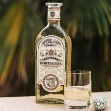 Load image into Gallery viewer, Fortaleza Reposado Tequila bottle with a glass of tequila and a decorative ball on a blurred natural background