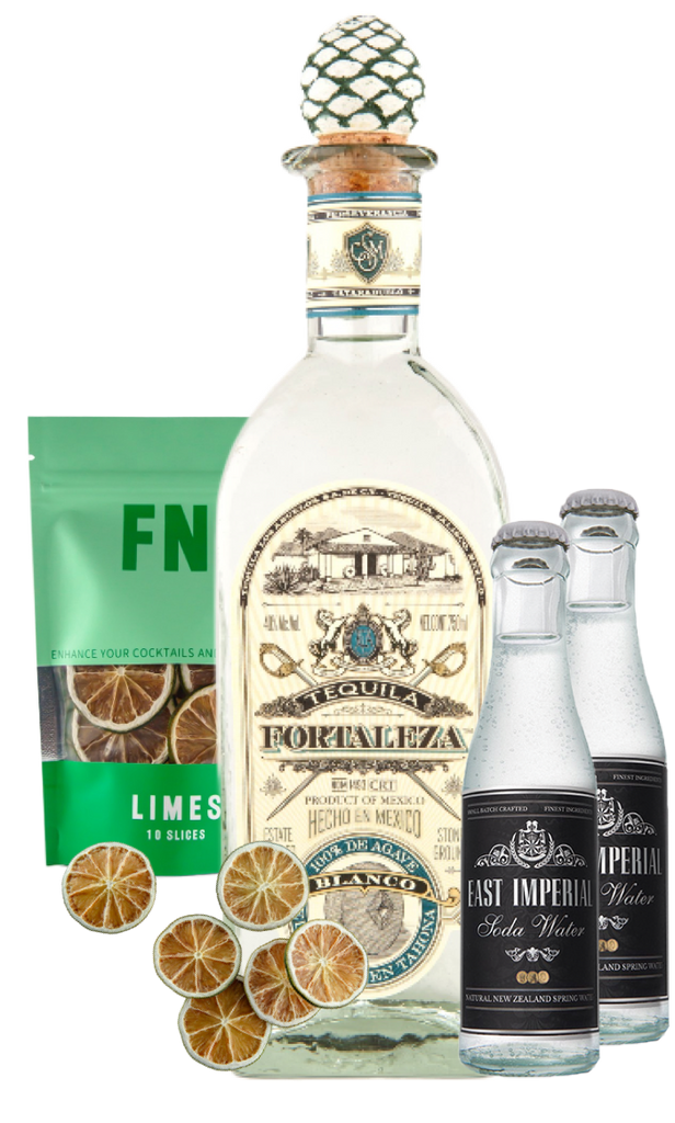 Fortaleza Blanco Tequila bottle with lime slices and two East Imperial Soda water bottles on a white background