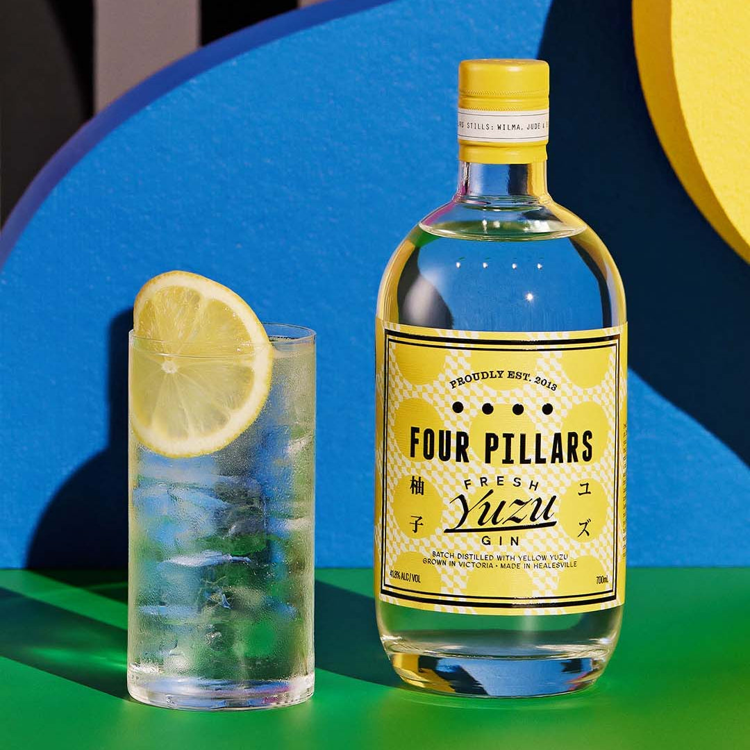 Load image into Gallery viewer, Four Pillars Fresh Yuzu Gin bottle with a glass of gin and tonic on a colorful background