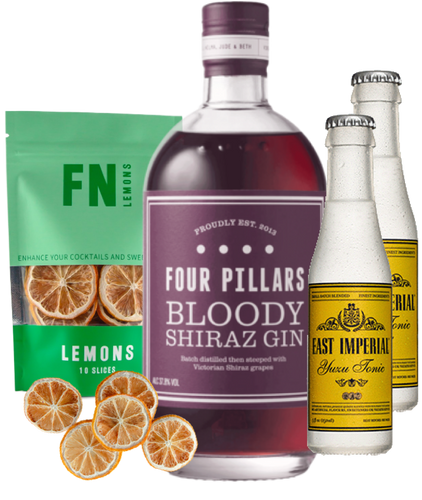 Bottle of Four Pillars Bloody Shiraz Gin with a pouch of lemons and two bottles of tonic water on a white background.