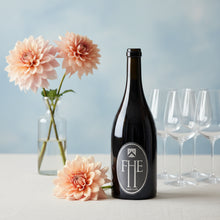 Load image into Gallery viewer, A bottle of Frenchmans Hill Expatrius Syrah next to flowers and glasses on a light surface with a light blue background