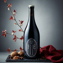 Load image into Gallery viewer, A bottle of Frenchmans Hill Expatrius Syrah with decorative elements on a dark background