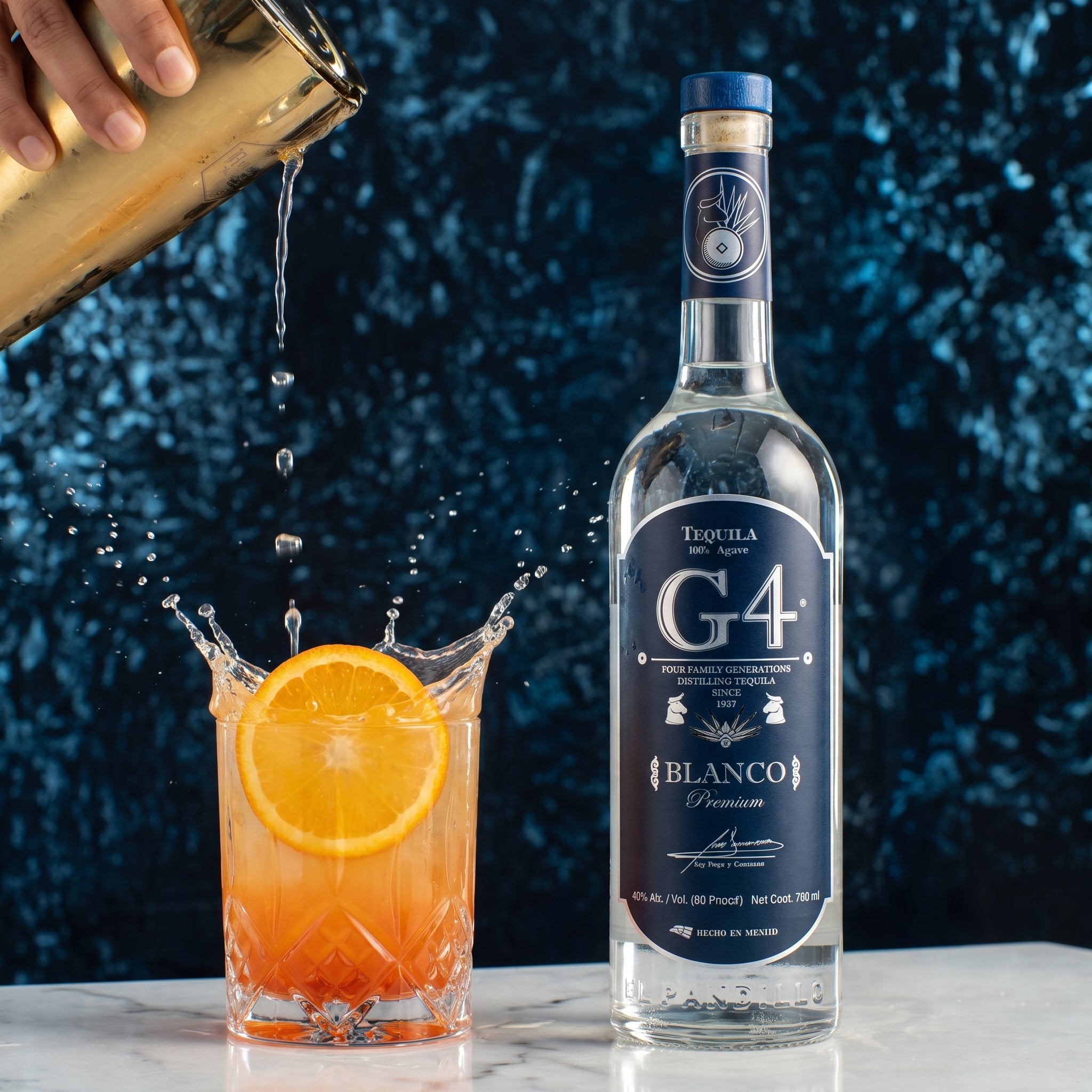 Load image into Gallery viewer, A bottle of G4 Tequila Blanco stands on a white marble surface next to a glass filled with an orange cocktail and an orange slice, with a hand pouring a drink from a shaker in the background against a dark blue textured backdrop.