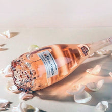 Load image into Gallery viewer, Bottle of rose wine on a light background with white flowers