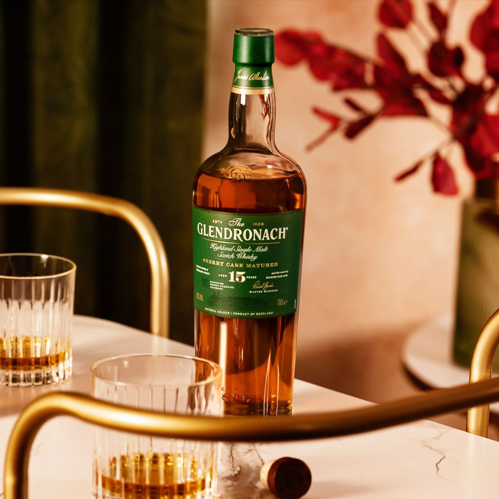 Glendronach 15 year old whisky bottle with glasses on a table