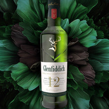Load image into Gallery viewer, Glenfiddich 12 year old single malt whisky bottle on a decorative leaf background