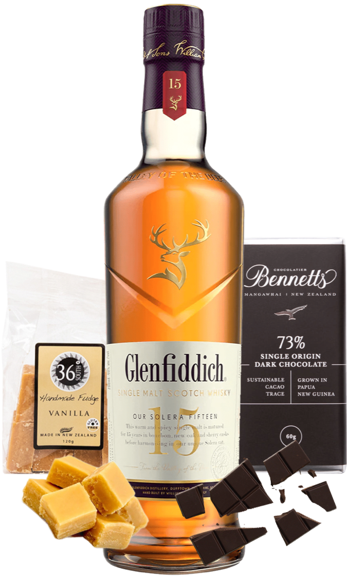 Glenfiddich 15-year-old whisky bottle with Bennetts Dark chocolate and 36 Degrees fudge on a white background