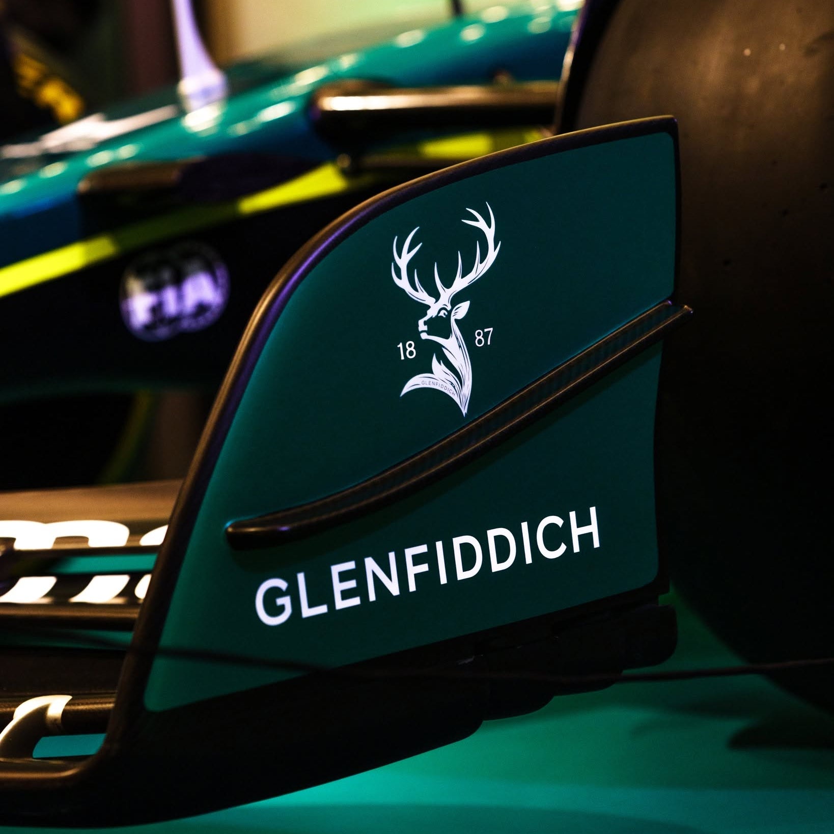 Load image into Gallery viewer, Glenfiddich Aston Martin Formula 1 car front wing with deer logo on a blurred background