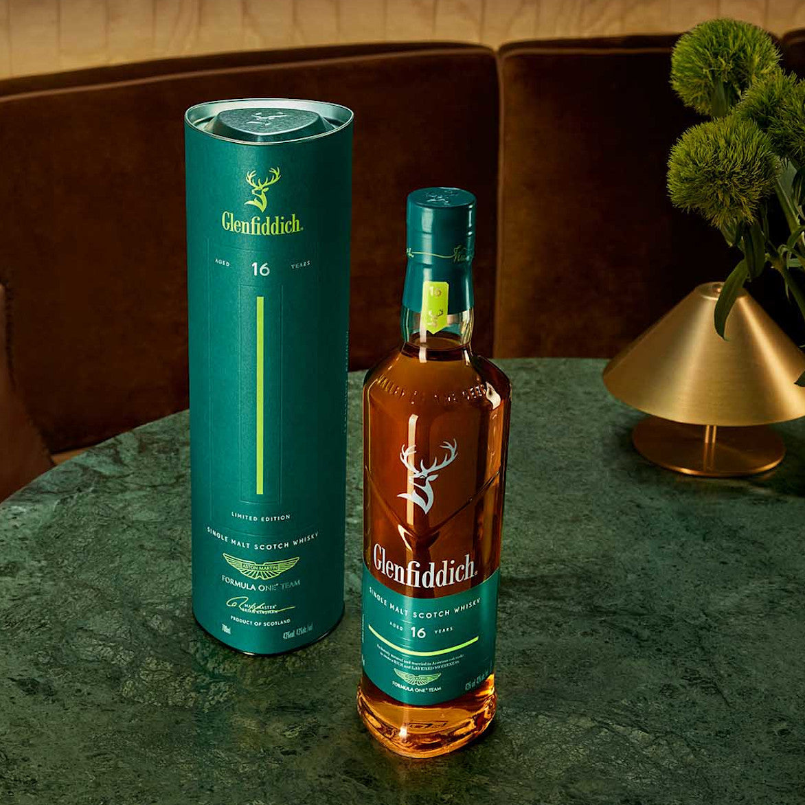 Load image into Gallery viewer, Glenfiddich 16 Year Old Aston Martin F1 Limited Editiony bottle and stylish gift box packaging on a table with a decorative background
