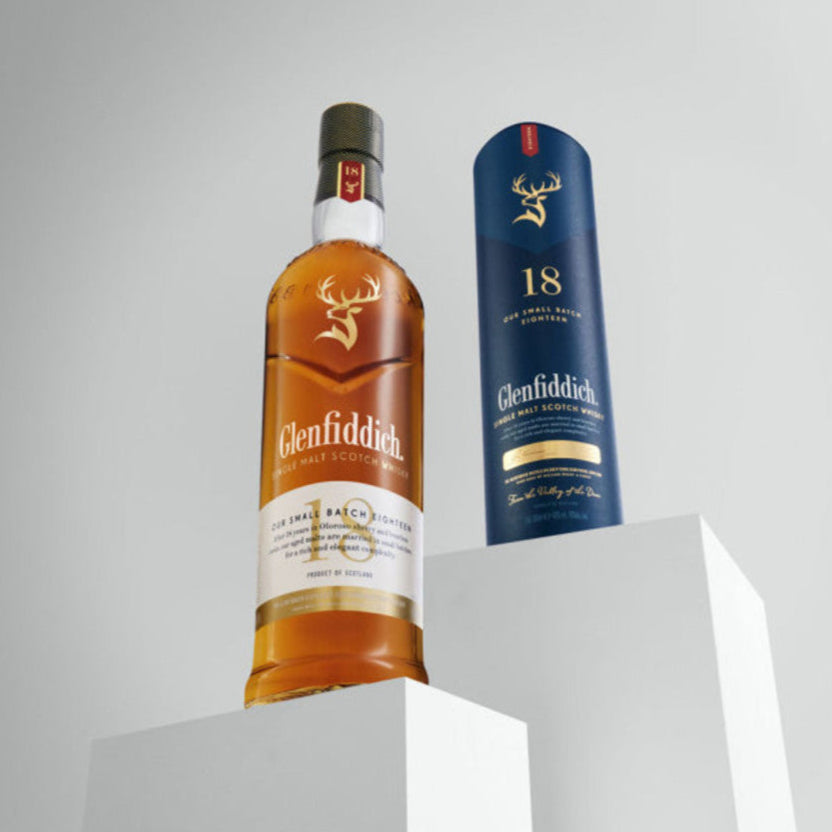 Glenfiddich 12 year old whisky bottle and packaging on a gray background