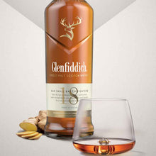 Load image into Gallery viewer, Glenfiddich 18 year old whisky bottle with a glass on a light gray background