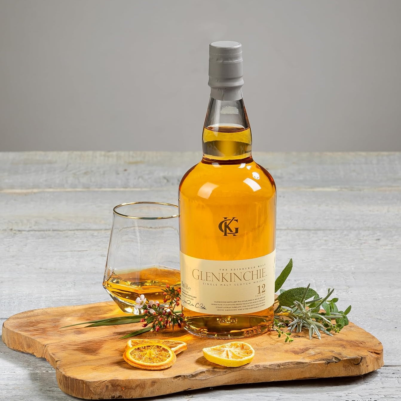 Load image into Gallery viewer, Glenkinchie whisky bottle standing on a wooden tray with a tumbler of neat whisky
