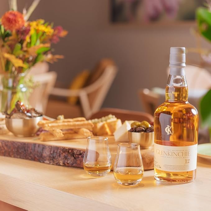 Load image into Gallery viewer, Glenkinchie whisky bottle on a table with a cheeseboard in the background and two glasses of whisky