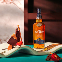 Load image into Gallery viewer, Bottle of The Glenlivet 18 year old whisky on a decorative plate with a blurred background
