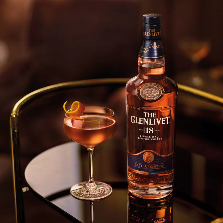 Load image into Gallery viewer, Glenlivet 18YO Single Malt Whisky on a glass tray together with a cocktail