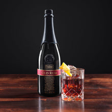 Load image into Gallery viewer, Bottle of Goslings-Old-Family-Bermuda-Reserve-Rum on a wooden surface with a cocktail garnished with a lemon twist.